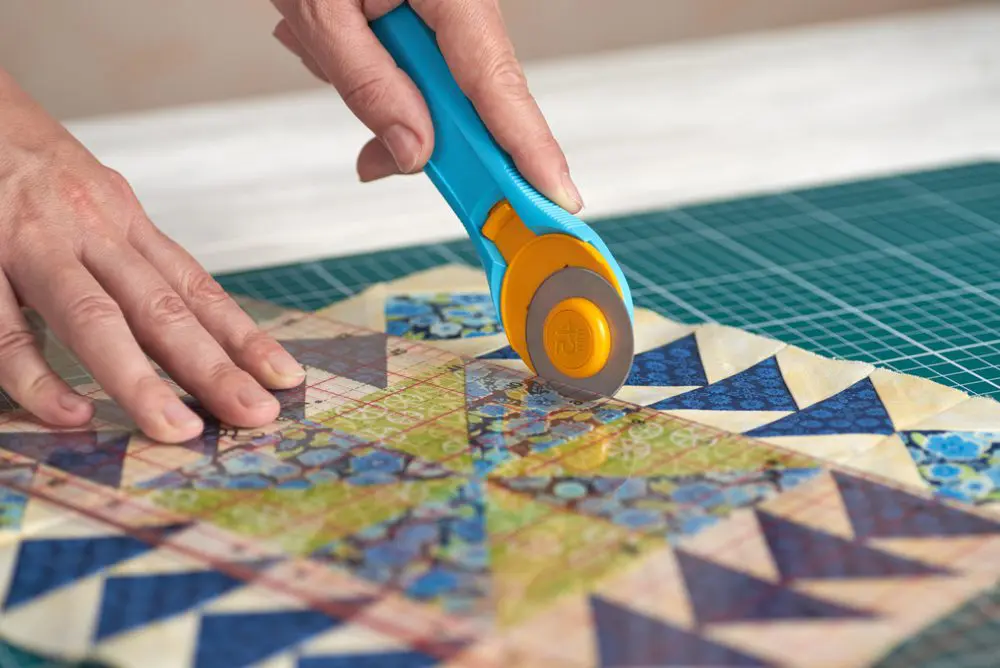 A person using a pair of scissors to cut paper