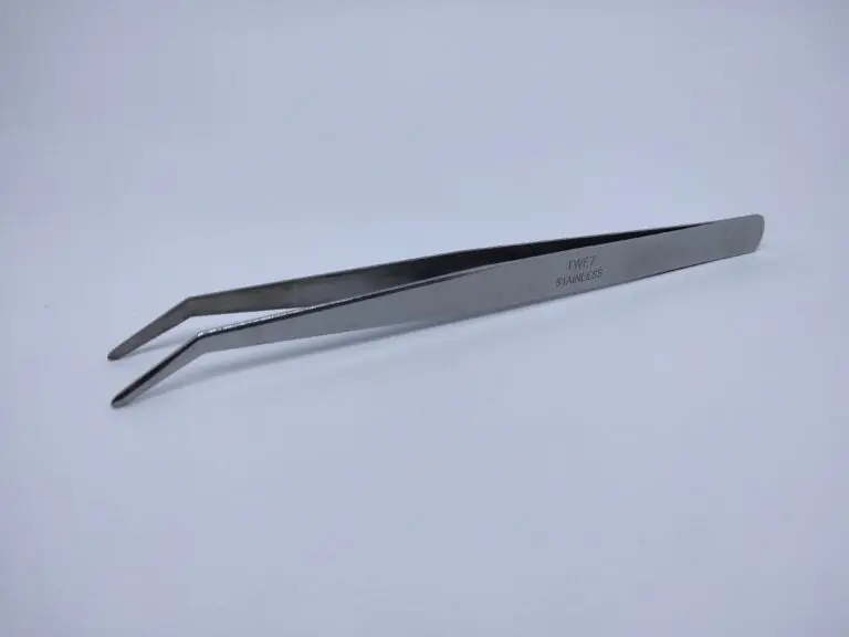 A pair of tweezers sitting on top of a table.